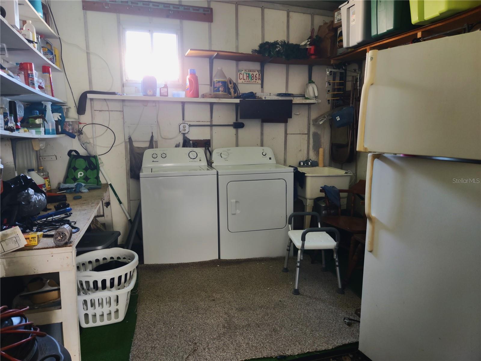 Shed offers workbench, laundry area and lots of extra storage.