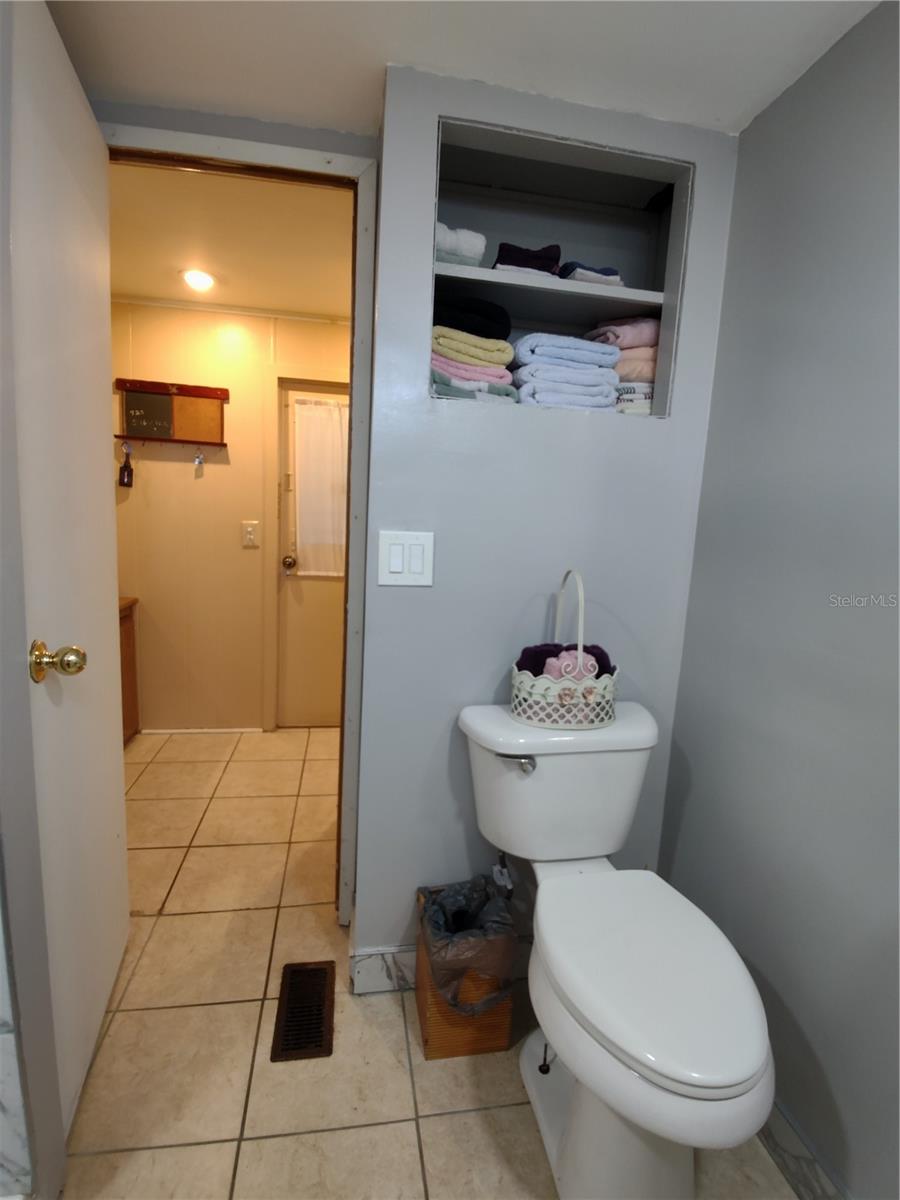 Main bath is directly across from the back door entry.