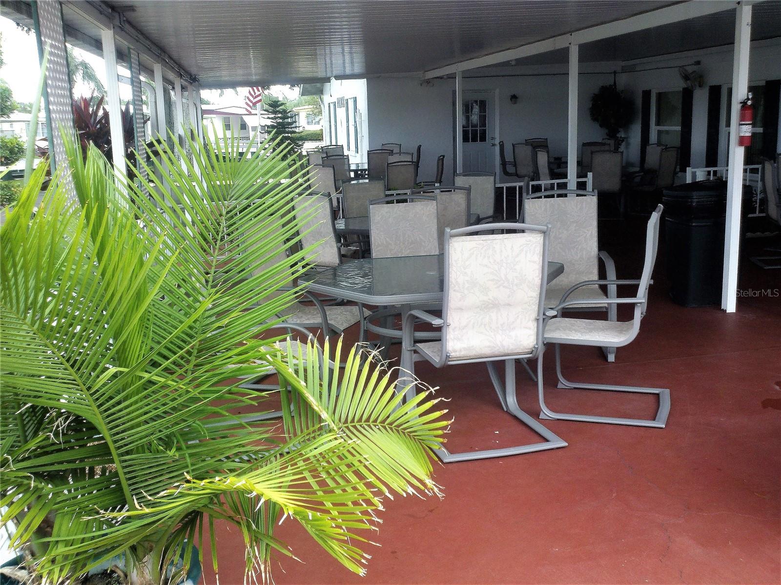 The covered patio is steps away from the pool area.
