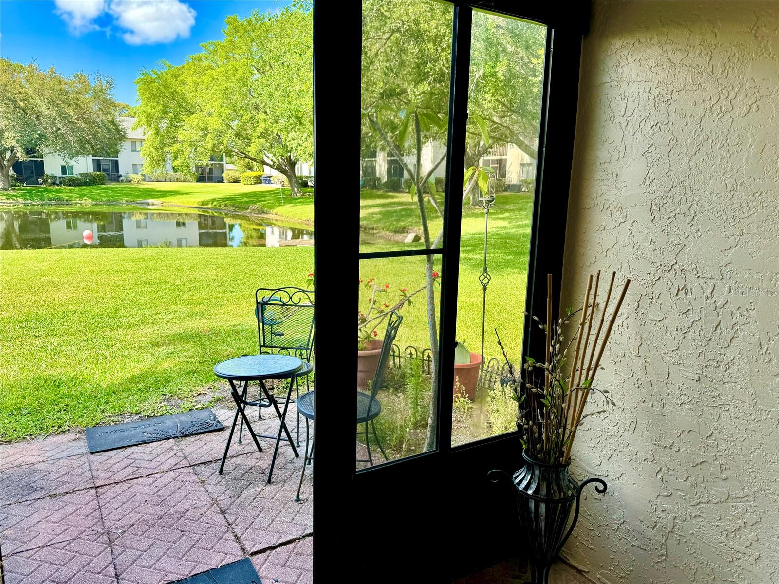 Private terrace with room to BBQ/grill or enjoy your morning coffee/tea, offering peaceful water views of the pond.