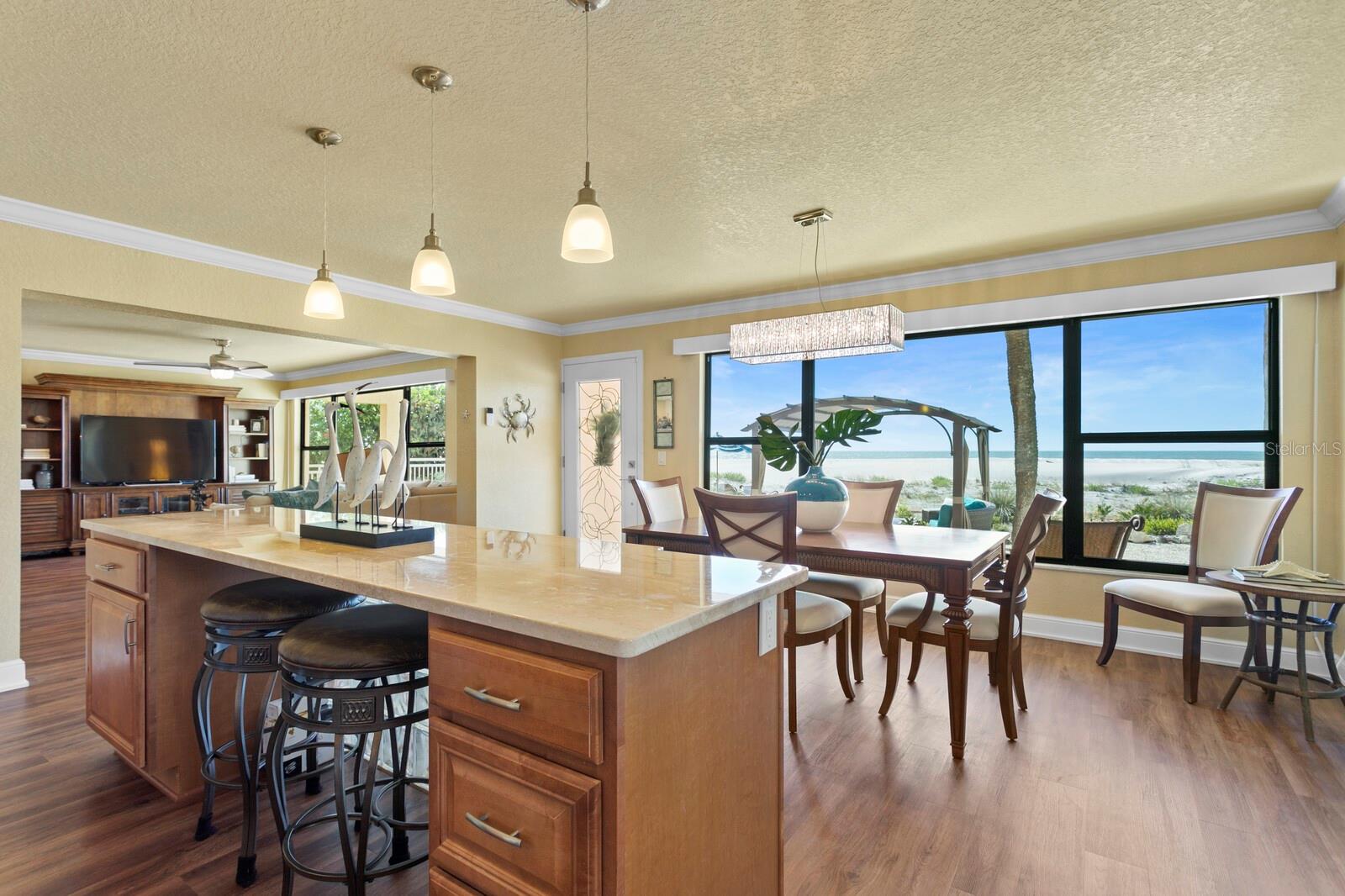 Enter into your beach home with its open floor plan design and an abundance of natural Florida light. Crown Molding, newer LVP flooring, newer windows and newer custom doors.
