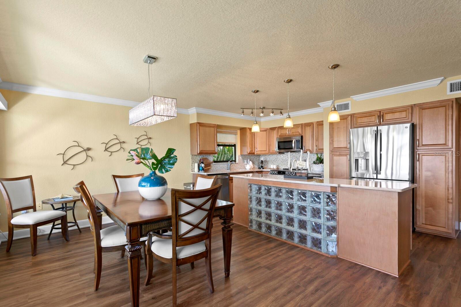 Kitchen with island opens to the dining room and also enjoys views of the beach.