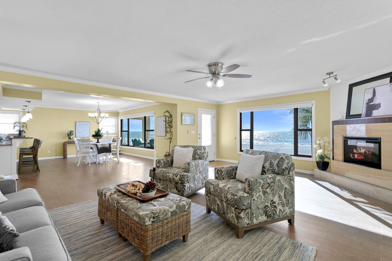 Get comfortable in this coastal room, complete with electric fireplace and panoramic beach views.