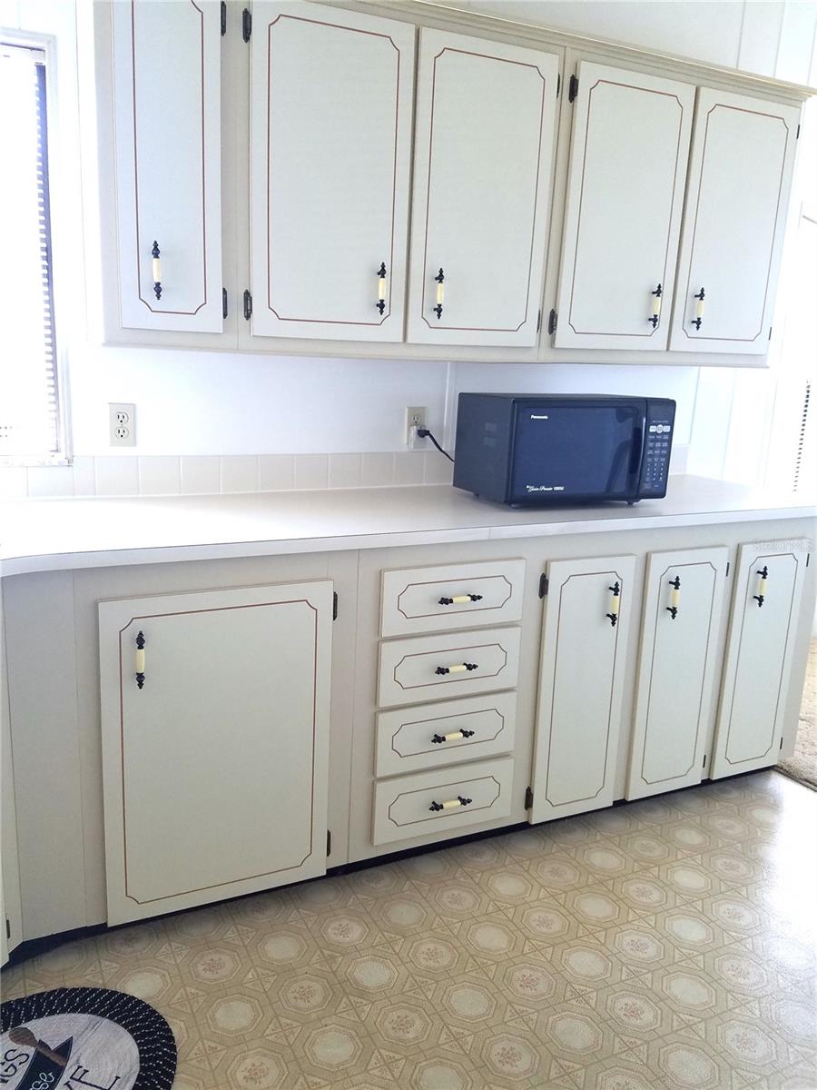 Lots of cabinets and counter space, vinyl flooring.
