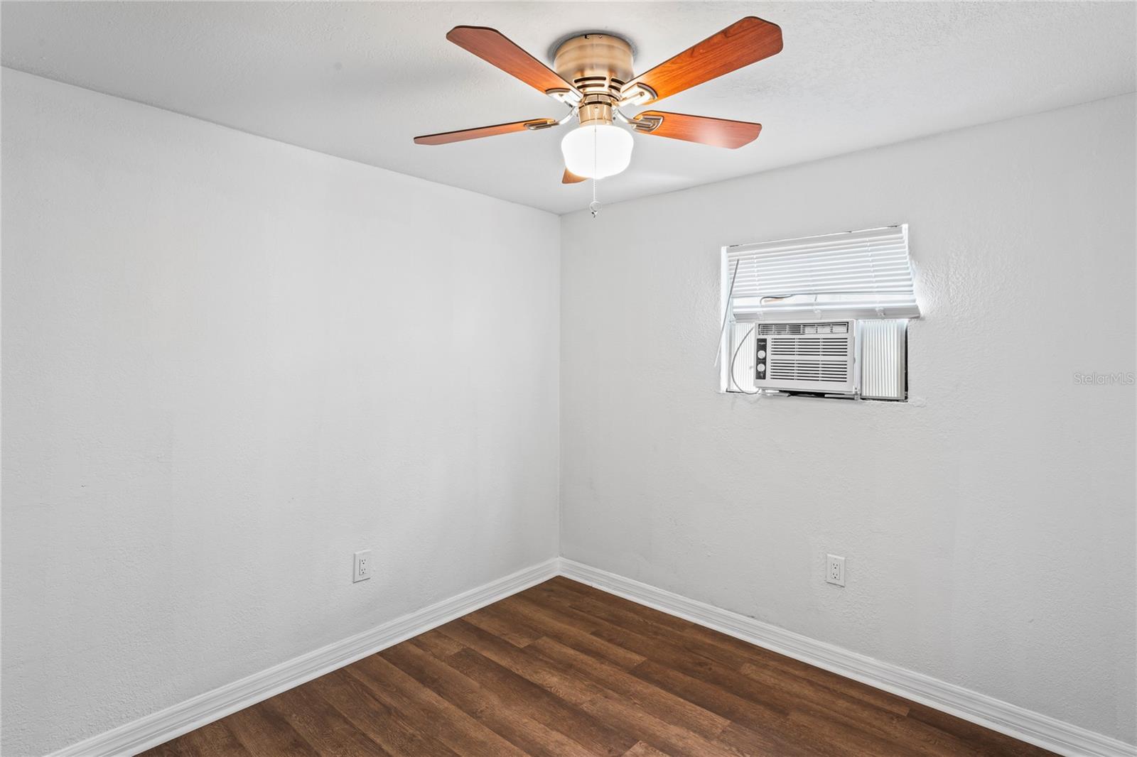 Guest or second bedroom, laminate flooring, ceiling fan and new air conditioner.