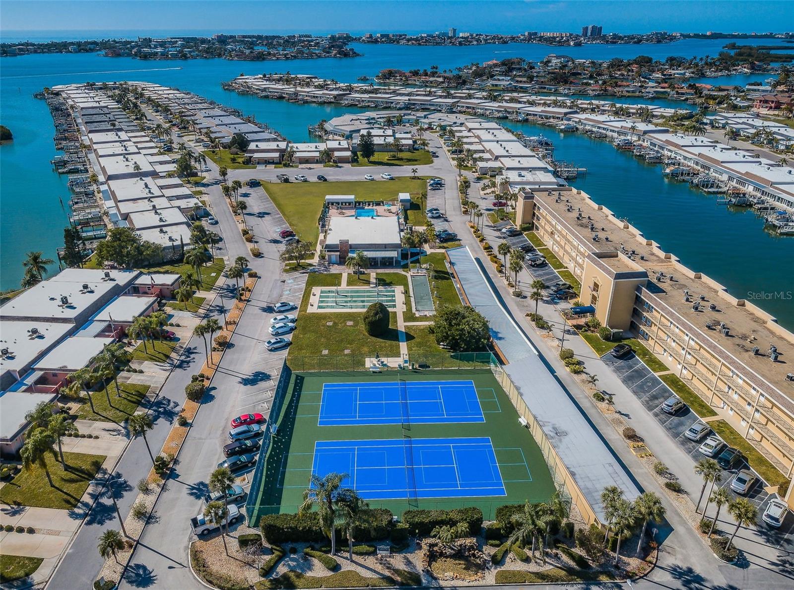 Aerial view of tennis courts, clubhouse, shuffleboard and pool