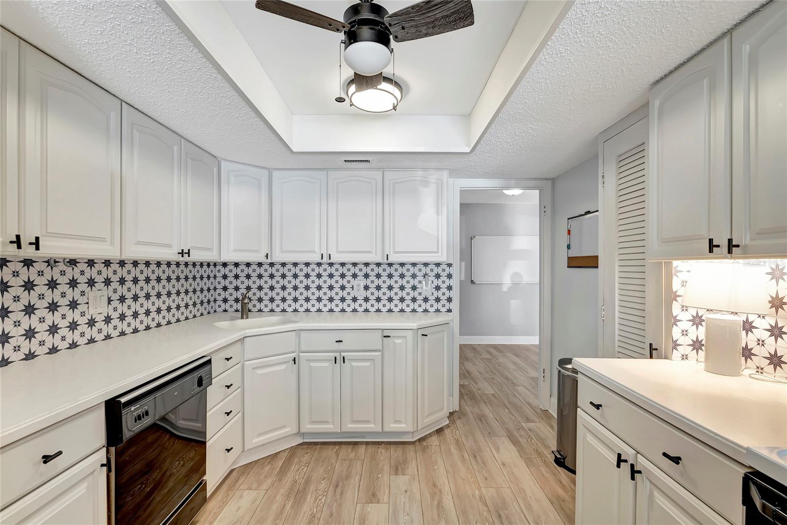 Surrounding you are rows upon rows of kitchen cabinets, offering ample space to stow away all your culinary essentials.