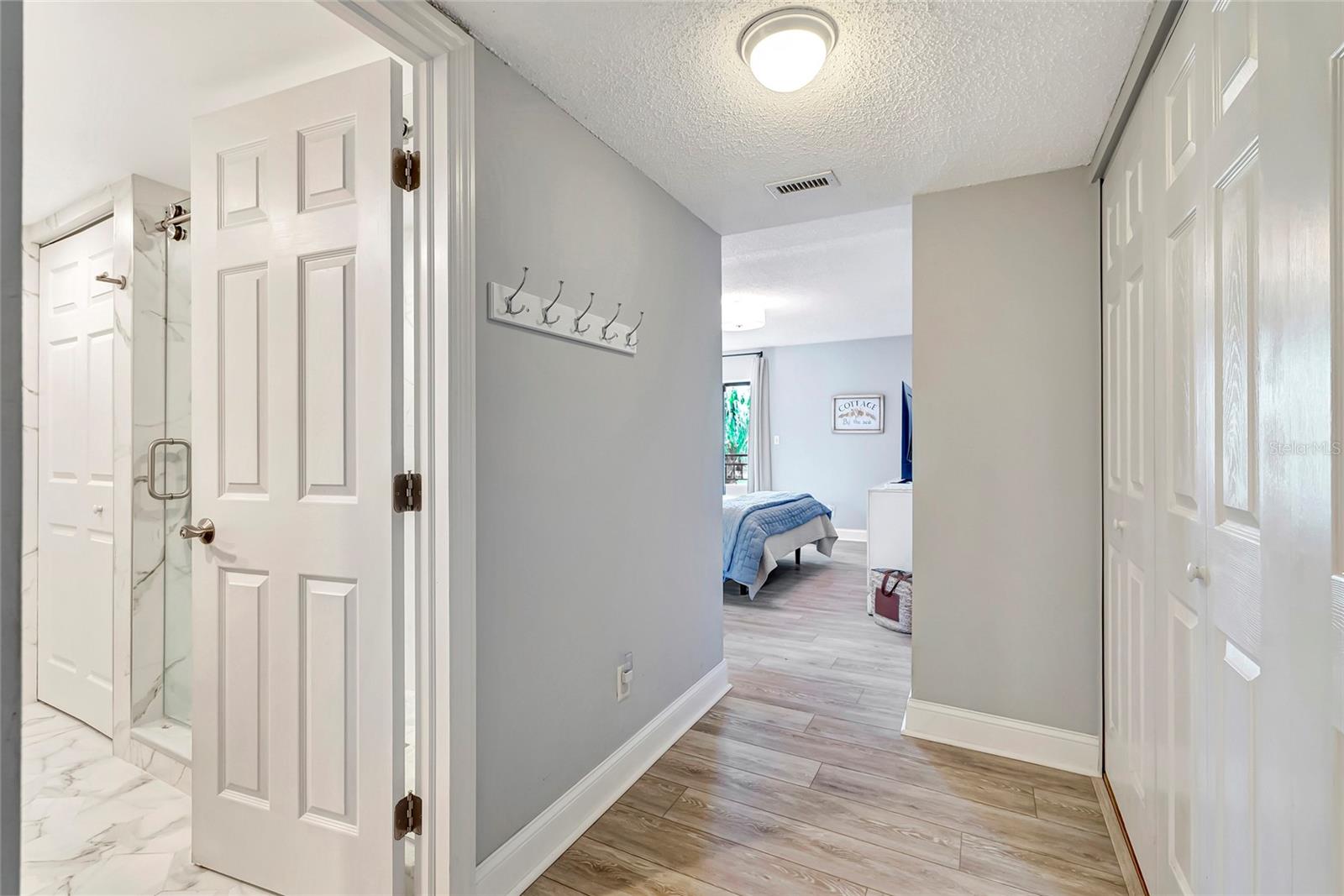 Follow the pathway from the primary bedroom to the second room, where comfort and charm await.