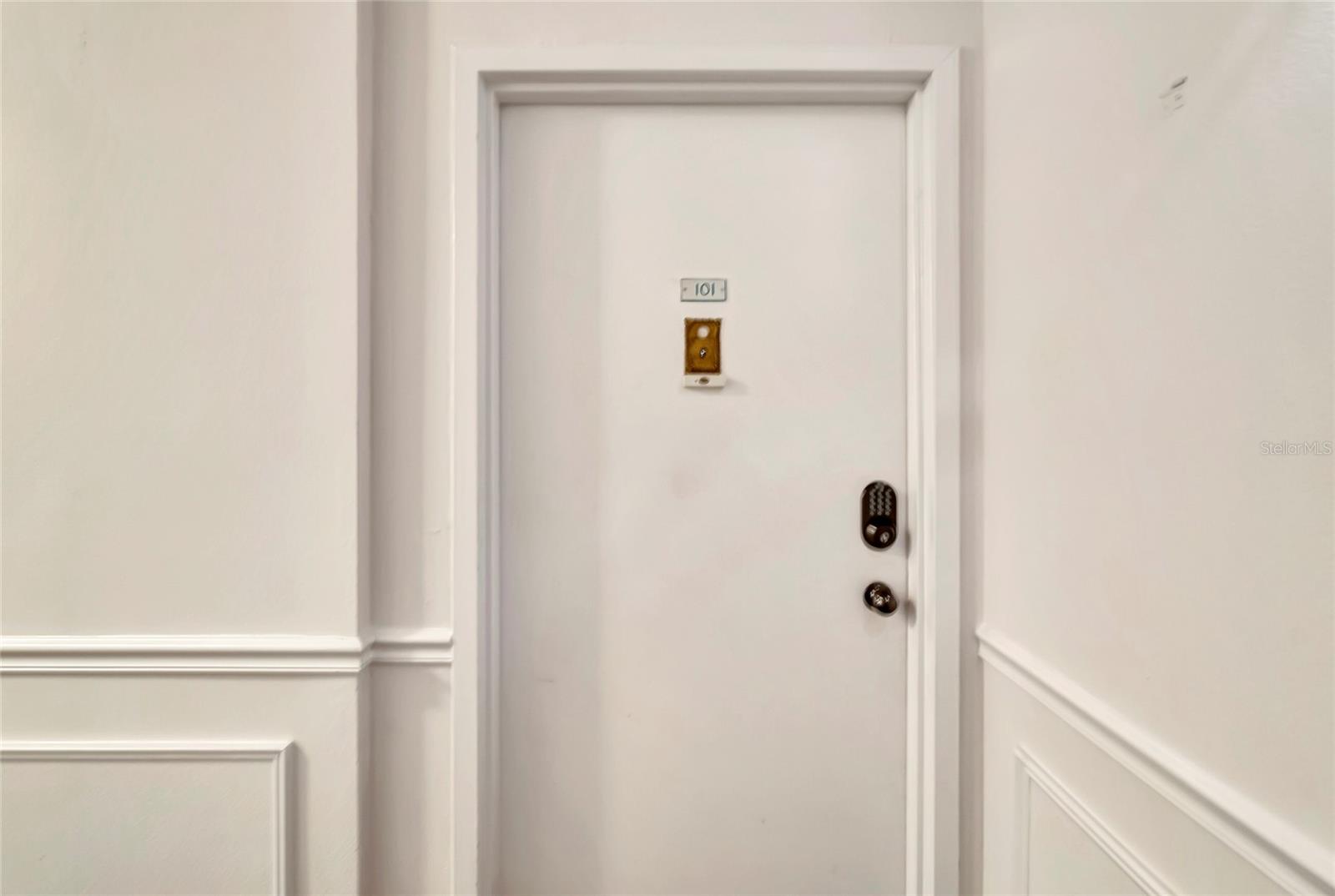 Picture the welcoming front door of our condo unit, standing proudly within the vibrant community.