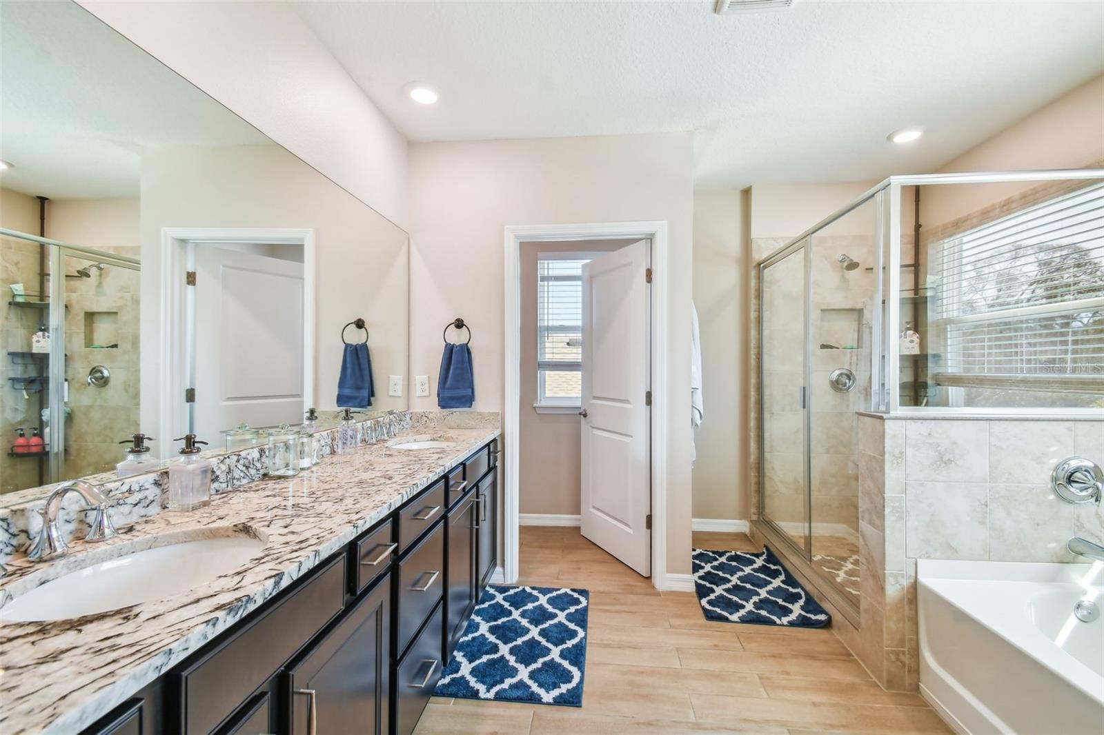 Master bath with his/hers closets, dual sinks, garden tub & separate shower