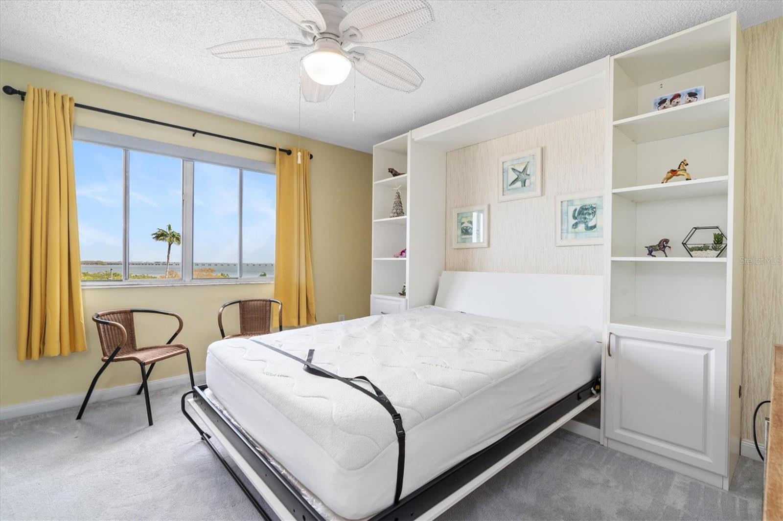 Bedroom 2 with murphy bed down, ceiling fan, and views of Tampa Bay