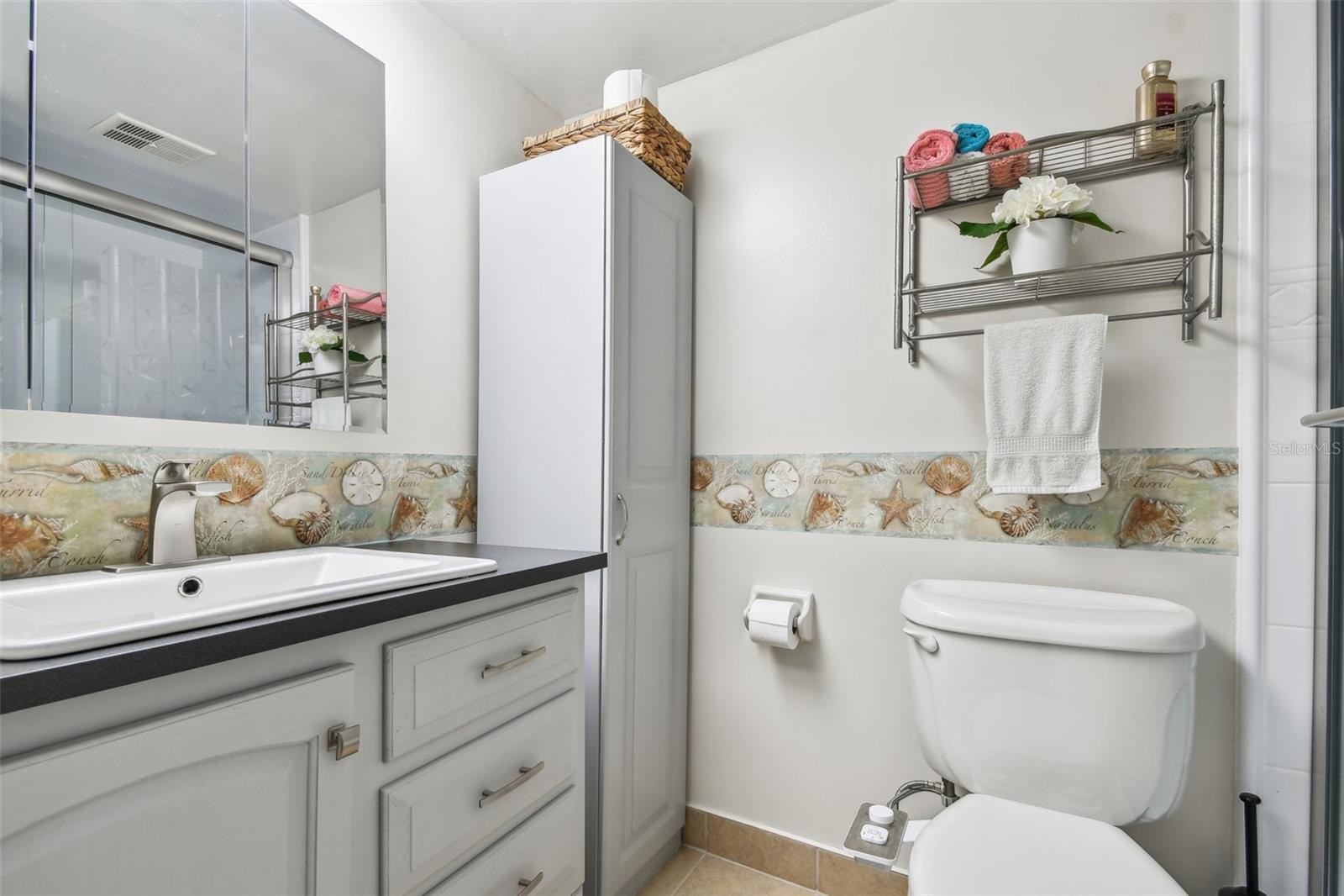 master bath with linen cabinet