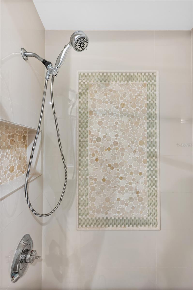 Guest Bath detailed tile work with elegant accent wall.