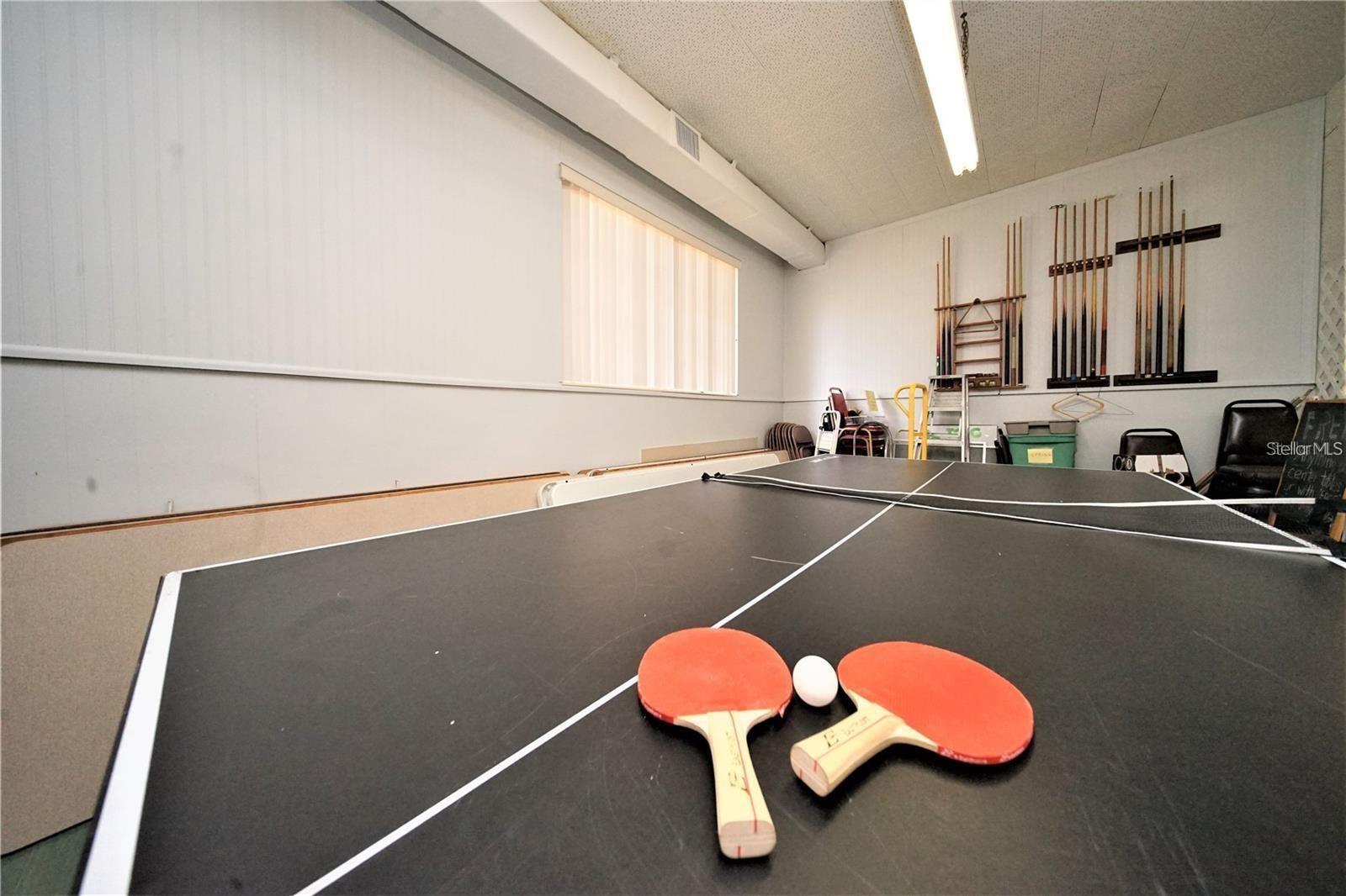 TABLE TENNIS INSIDE OF TEH COMMUNITY CLUBHOUSE