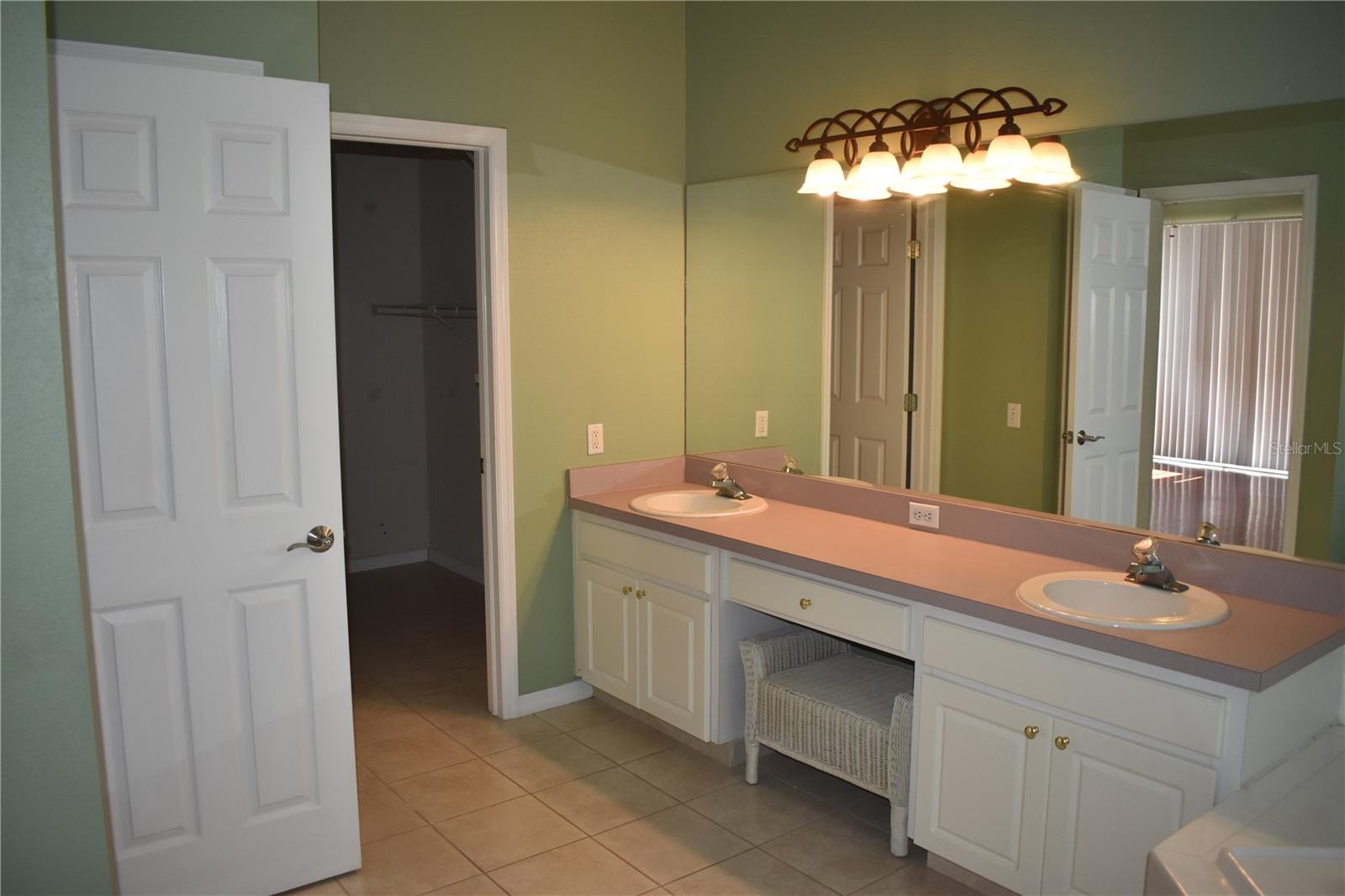 x large master bath with walk in closet walk in shower and garden tub
