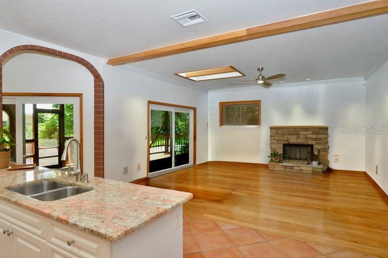 Virtually staged... Another skylight in this family room off of kitchen and lanai access