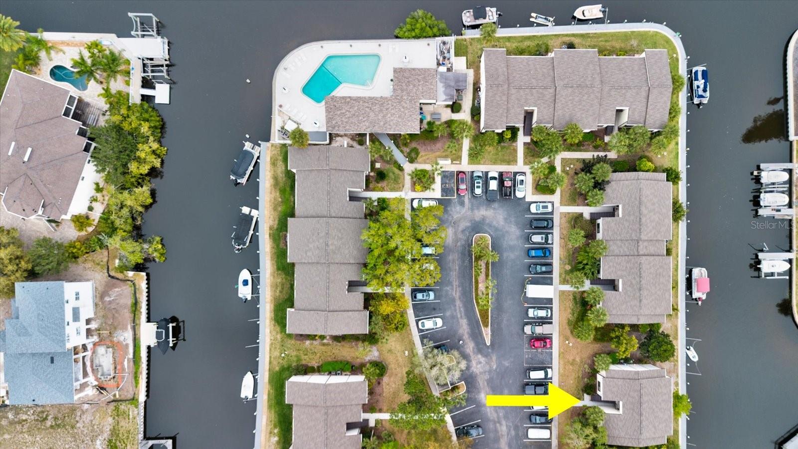Aerial View  of Community Pool, Clubhouse, & Community Parking In Relation To Your Condo Building