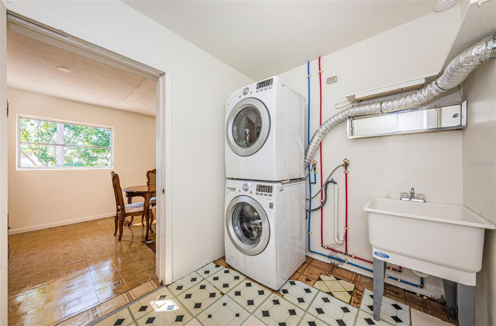 Large laundry room with utility sink.