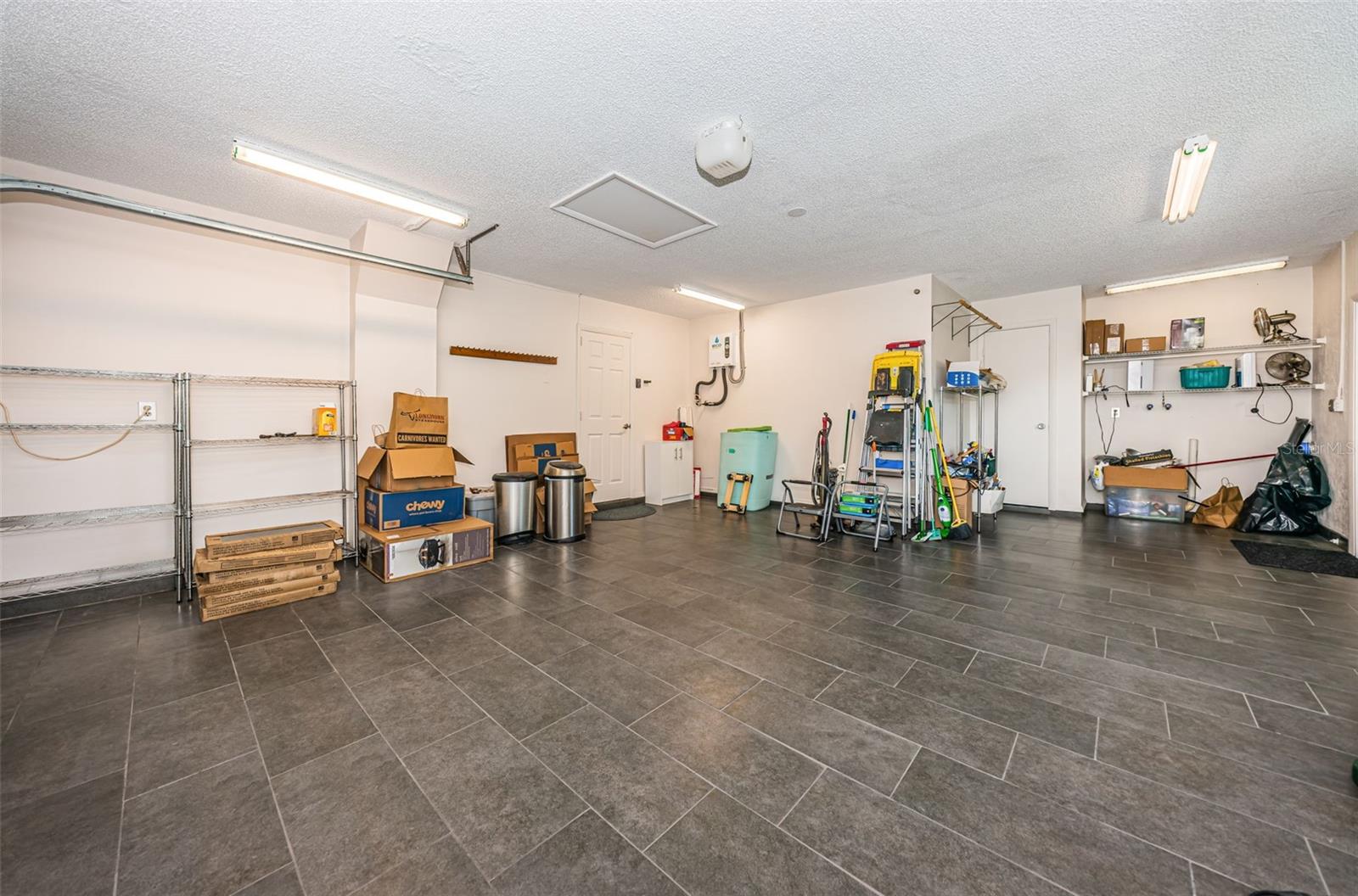 oversized 2 car garage with tile floor