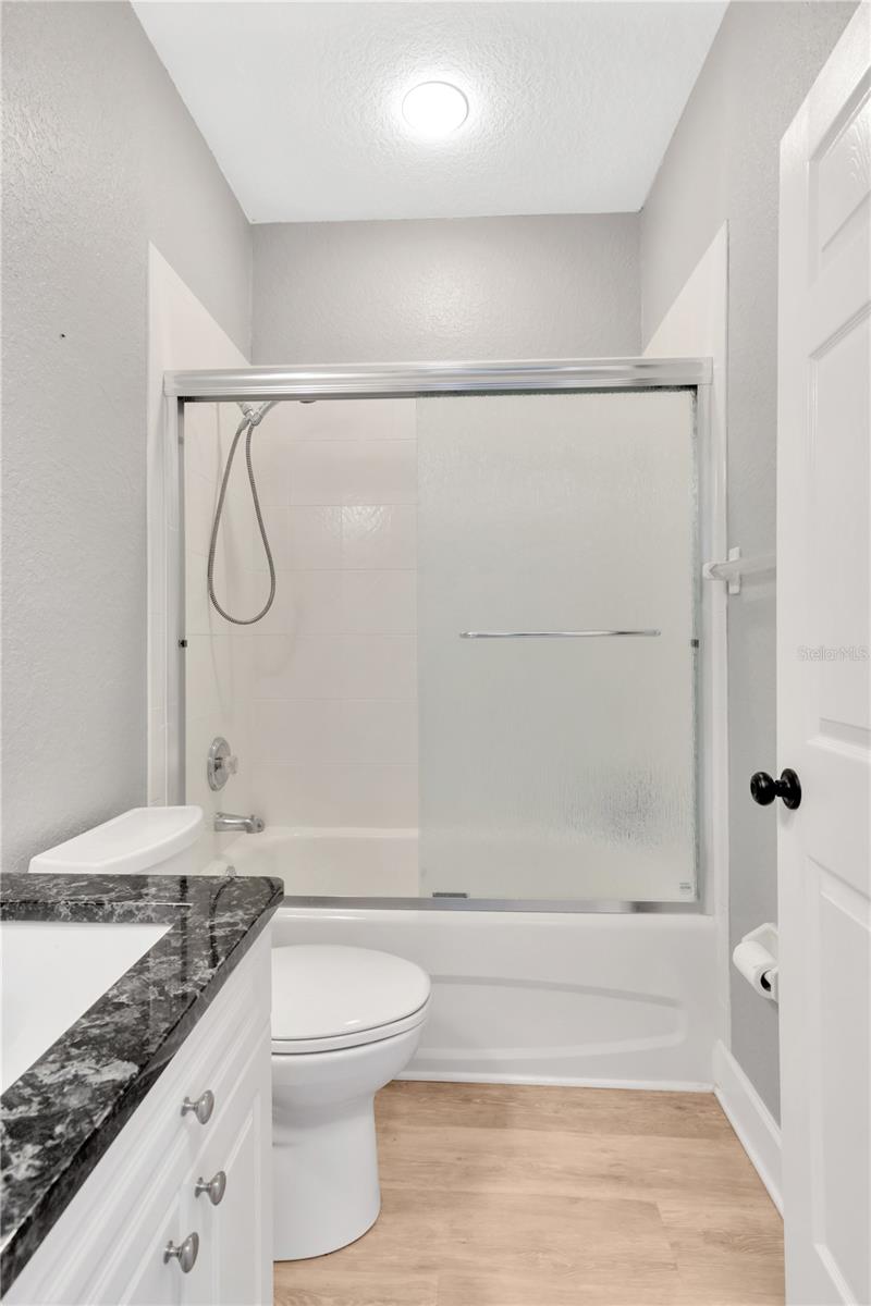 Half Bathroom located in Garage with Laundry Tub/Sink. Could change to a Decorative Sink/Vanity Cabinet very easily.