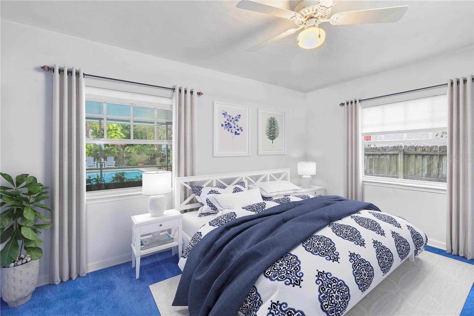 This photo is virtually staged. 2nd bedroom located downstairs with a view of the pool and screened patio. This is the only photo in the listing that is virtually staged.