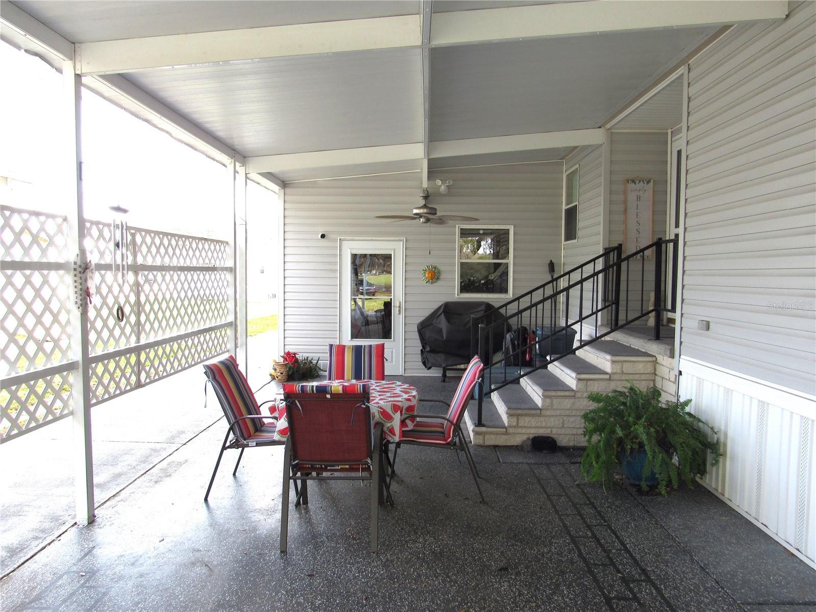 Carport seating area, main entry, large attached utility room.