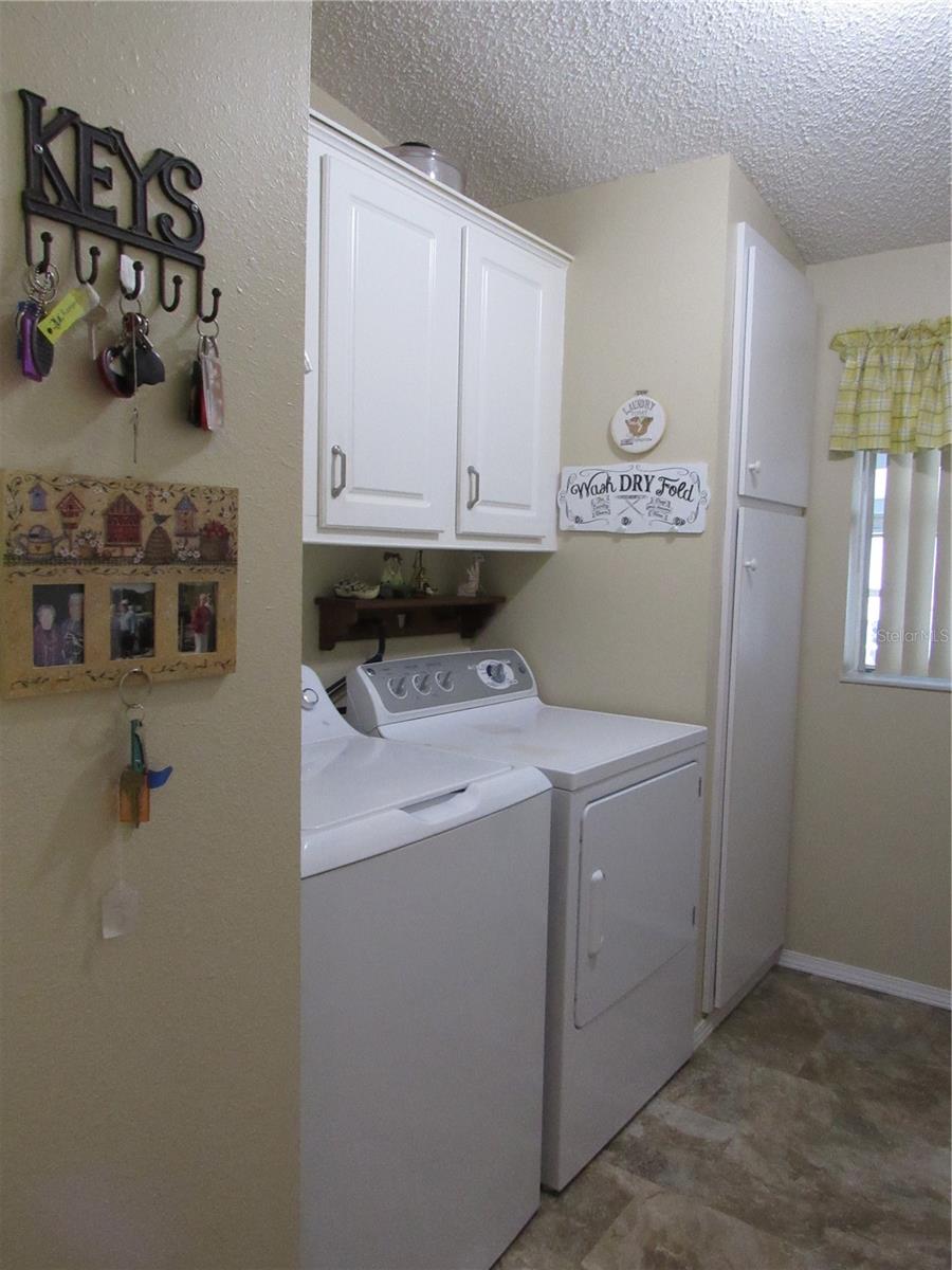 Laundry room featuring pantry with sliding drawers.