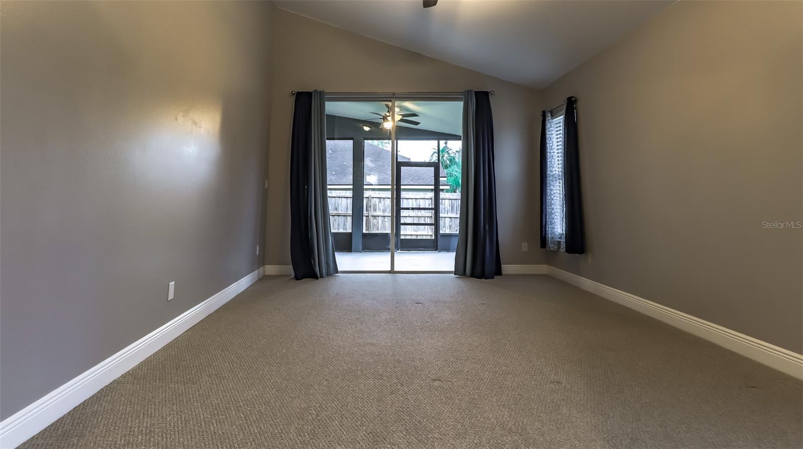 Large Primary Bedroom with plush carpets and sliding glass doors to Lani.