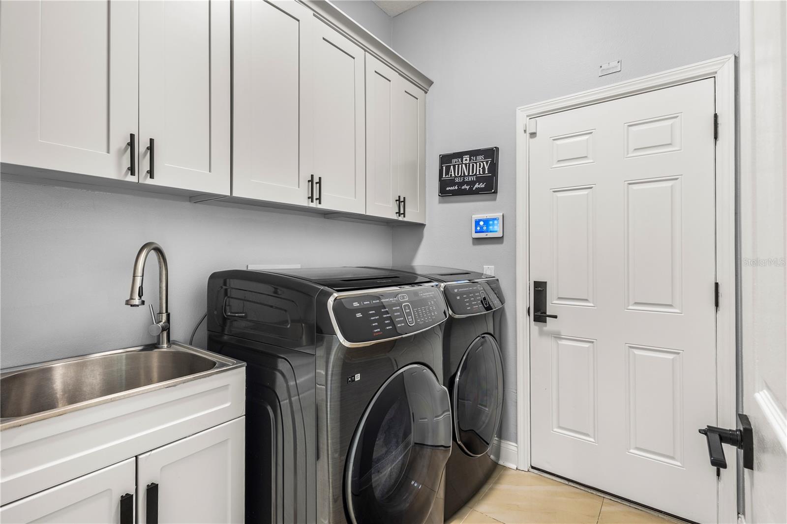 Laundry room with sink and custom cabinets