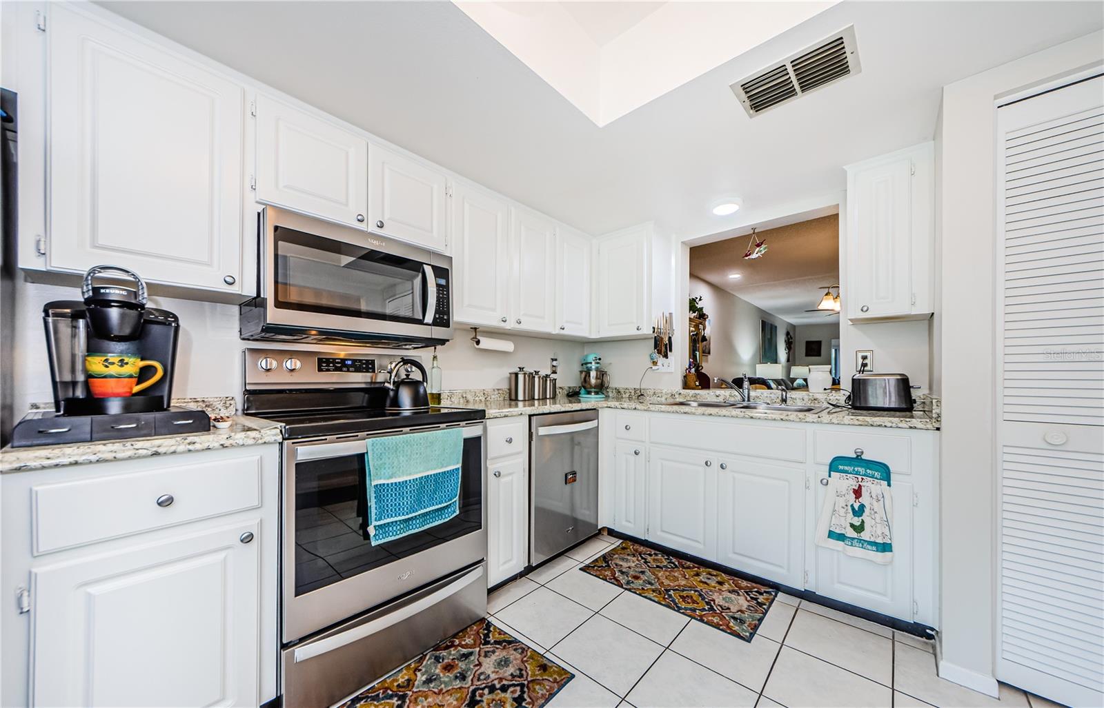 Stainless Steel Appliances. Pantry on the Right. Kitchen Opens to Dining & Living Room Beyond. Perfect if You're Hosting and Don't Want to Miss Out on the Revelry.