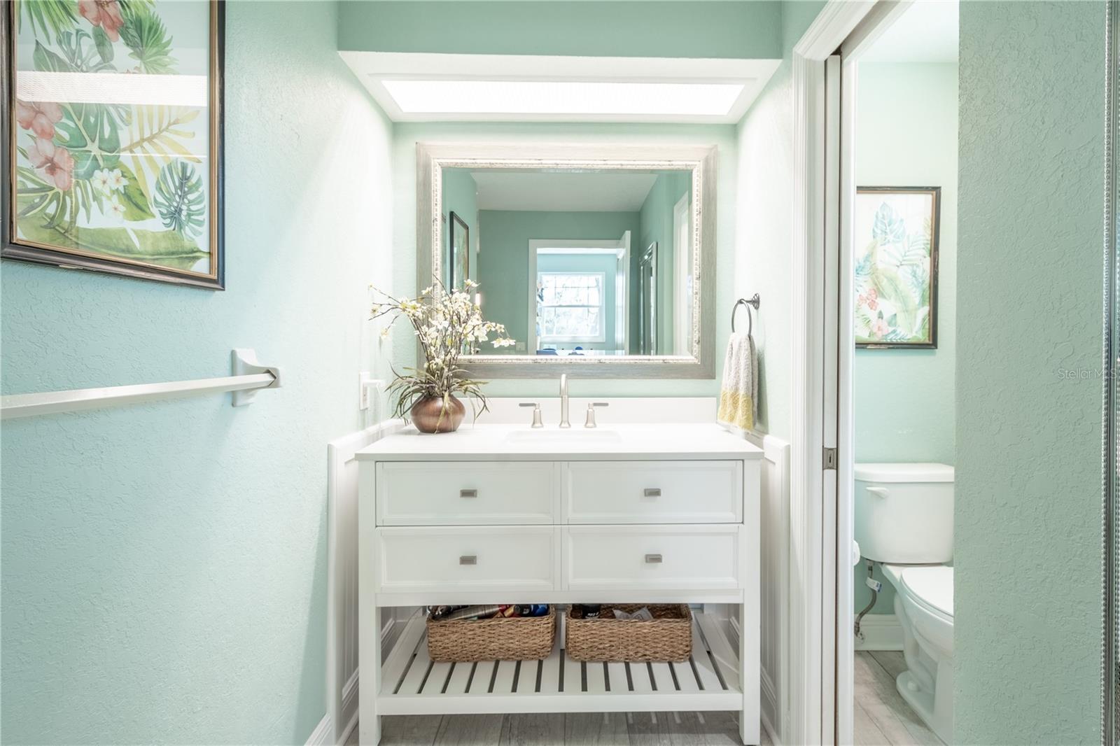 The upstairs primary ensuite bath fetures a mirrored vanity with storage and a w/c.