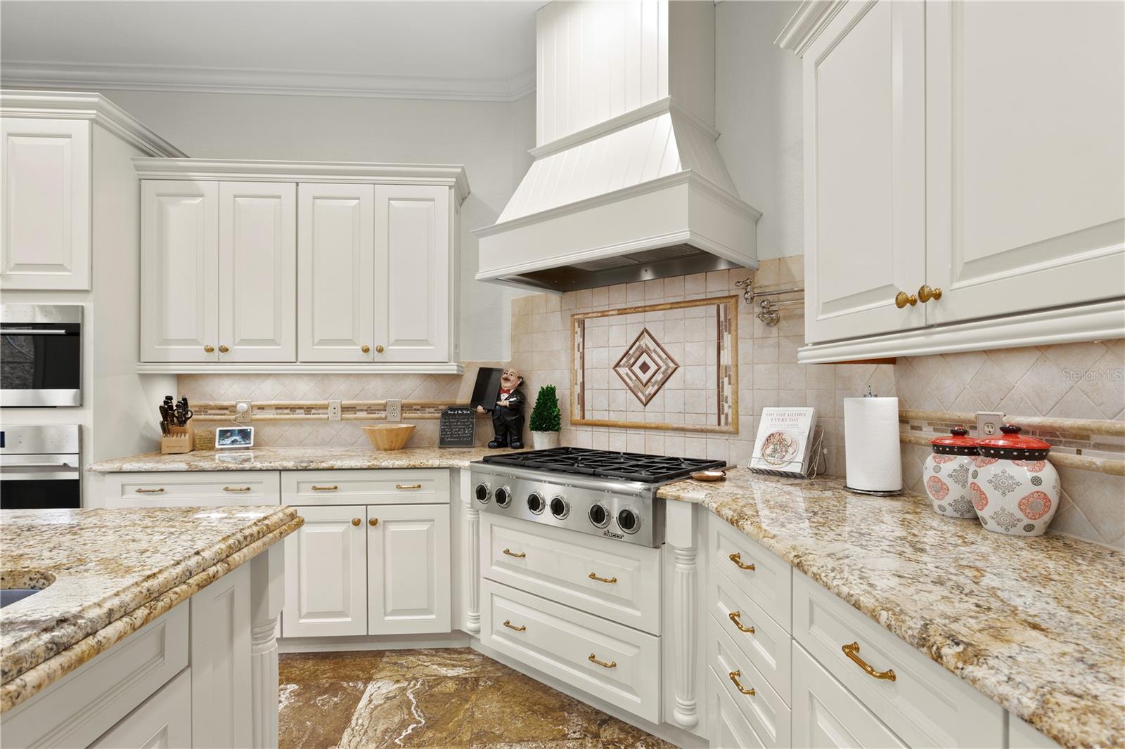 A gorgeous, remodeled kitchen is anything but ordinary with stunning cabinetry and tiled backsplash!