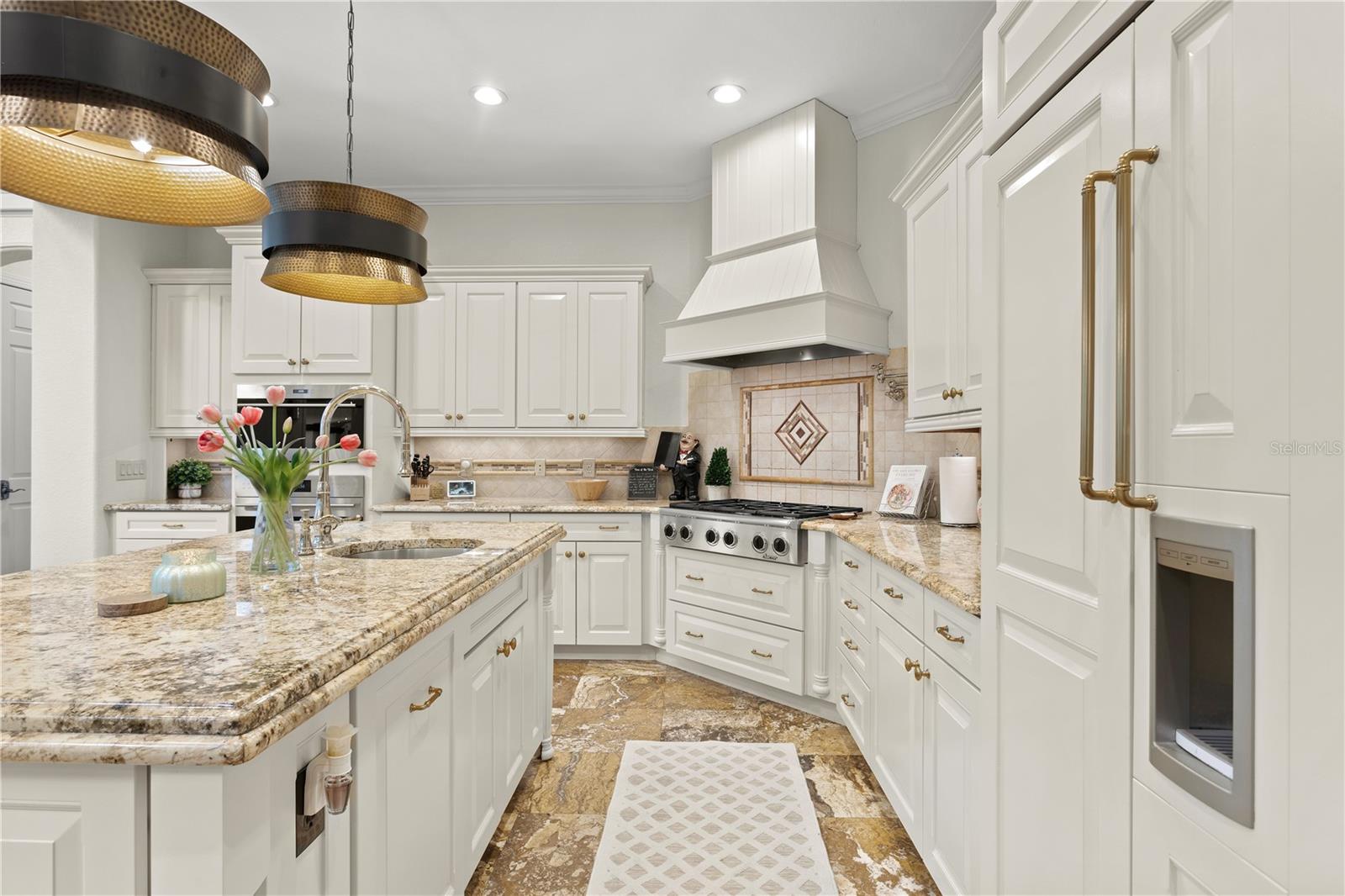 Stunning cabinetry, tiled backsplash, flooring & countertops! Built-in refrigerator, gas cooktop and four-drawer dishwashers!