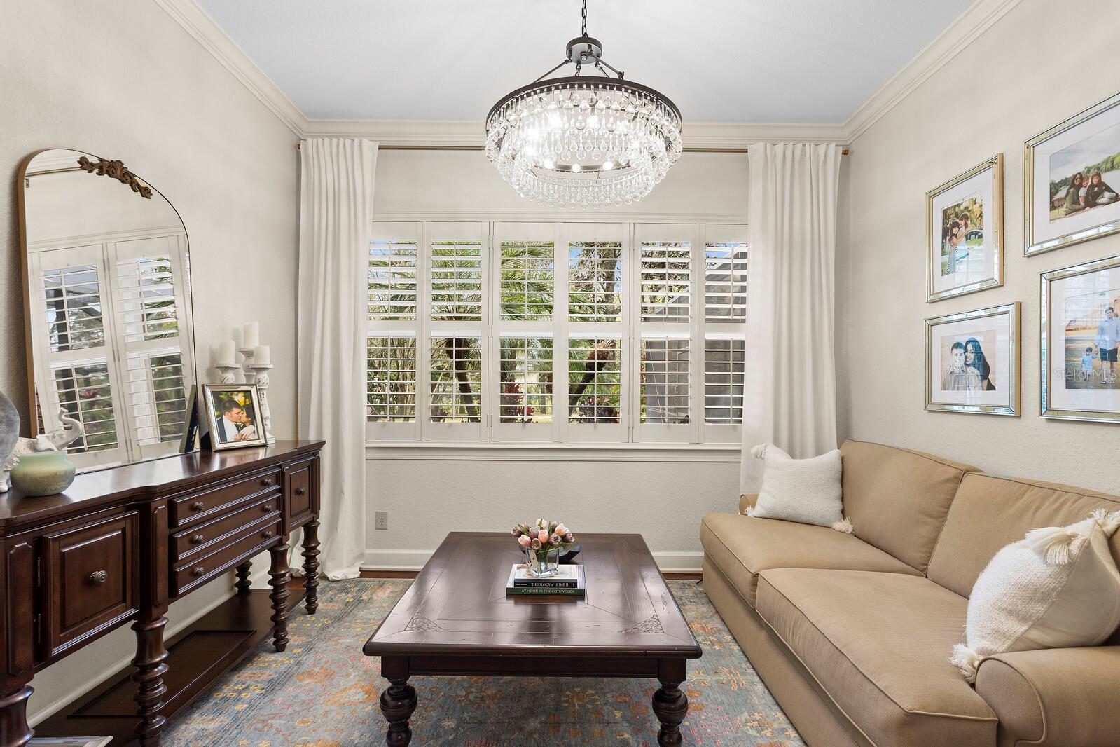 Gorgeous chandelier and plantation shutters!