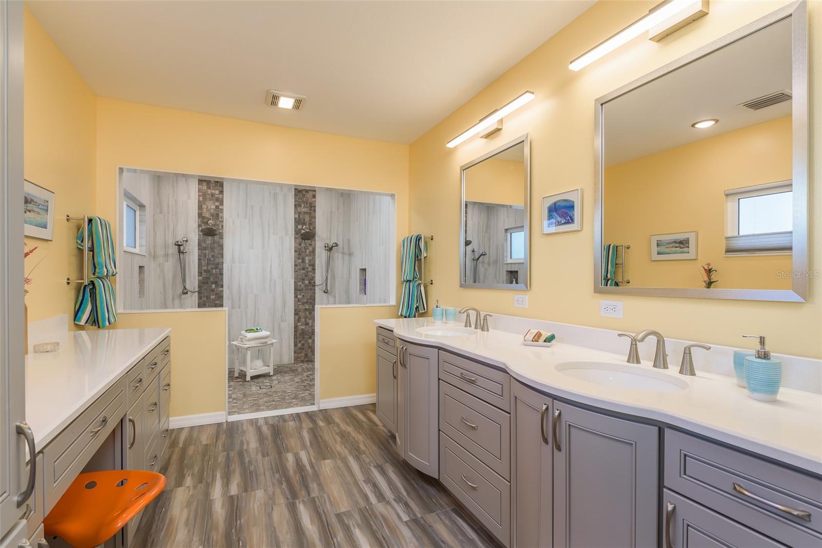 Primary Bath features double sinks, make-up counter, and spacious all-tile shower with double shower heads