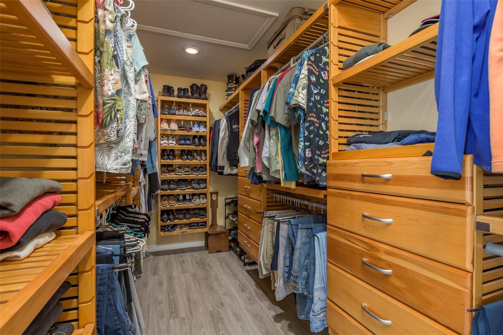 Primary walk-in closet with wood built-ins