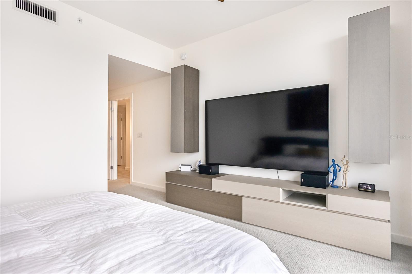 TV and built-in cabinet with even more storage in the Primary Suite