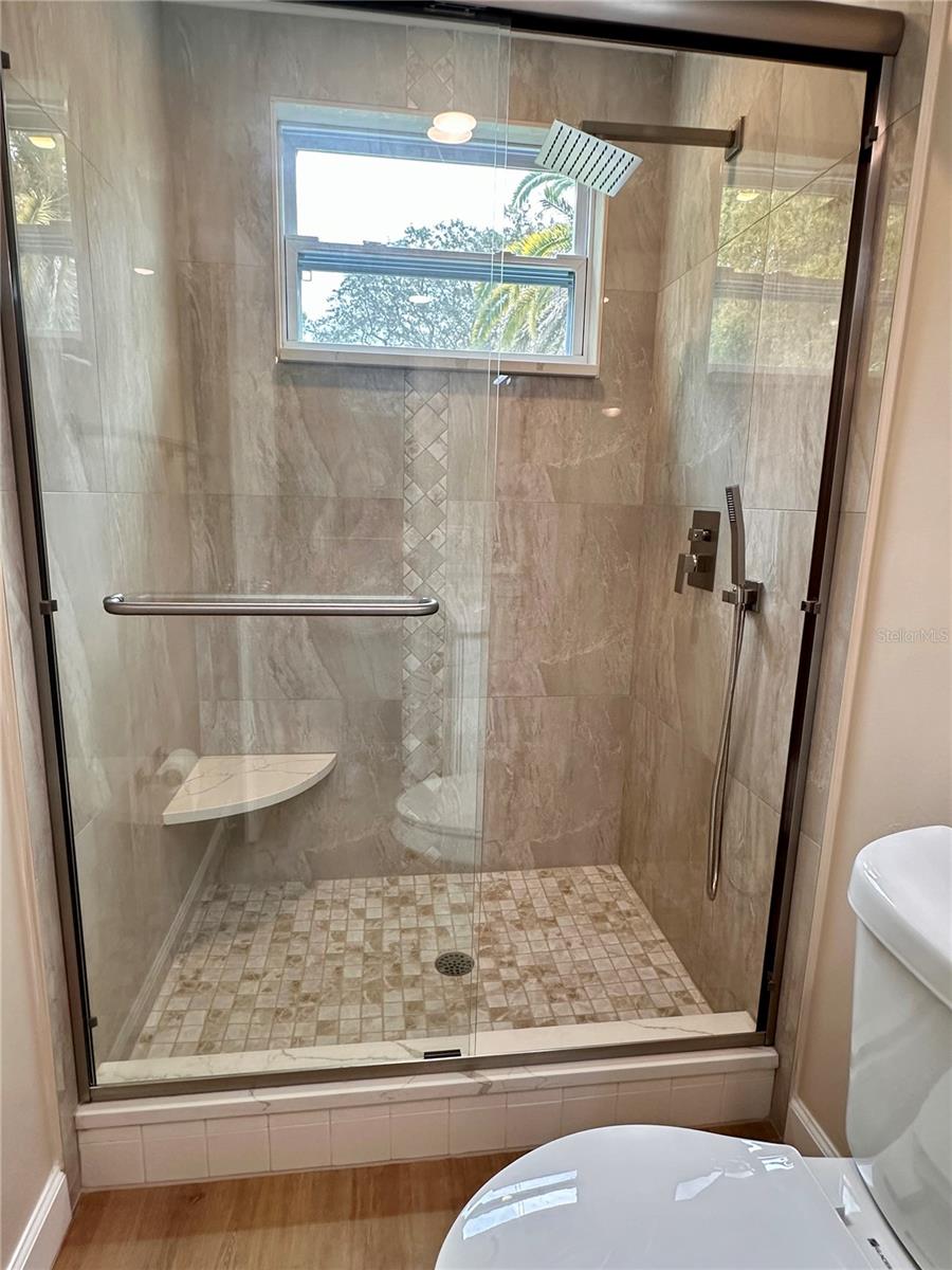 Beautiful shower with seat in master bedroom