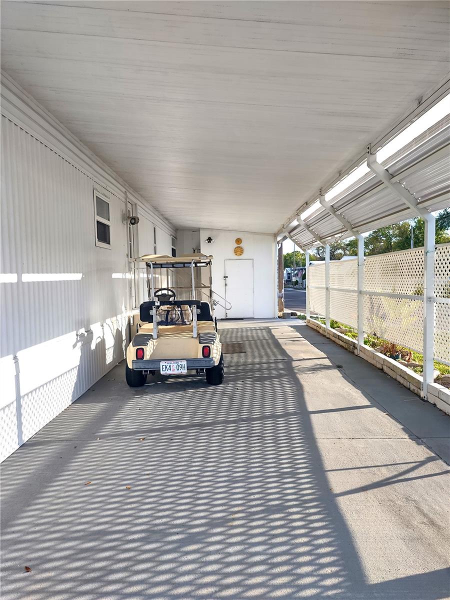 Carport can accommodate a car and golf cart