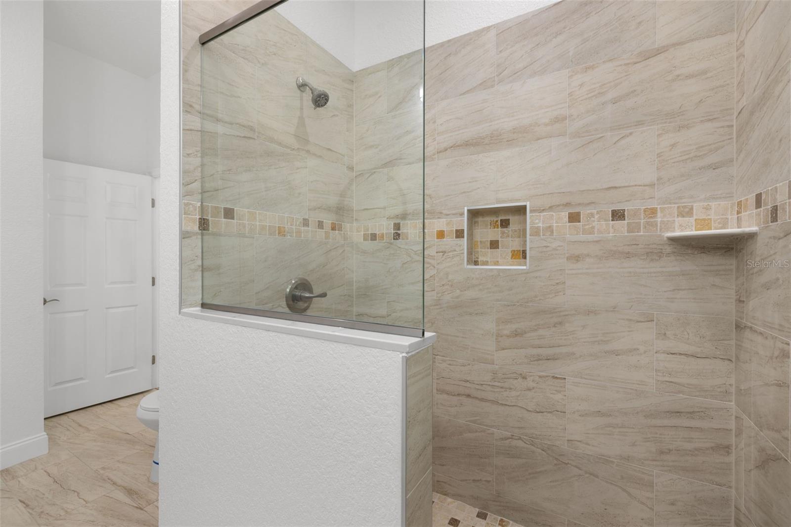 Shower w Glass Enclosure and Tiled walls