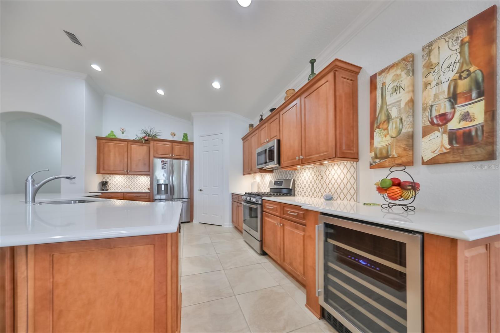 Kitchen with all wood cabinets and undermounted lighting, as well as a temperature controlled wine cooler are just a few of the extraordinary touches in this condo.