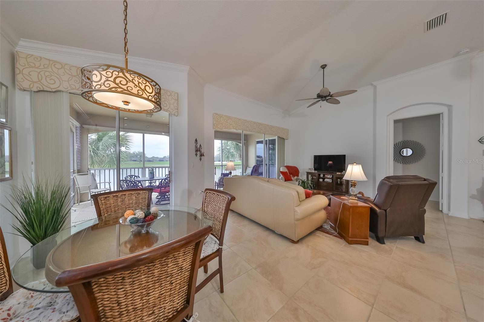 The dinette area is complete with a water/golf course view and tropical feeling table and chairs.  Remember...this is a TURN-KEY condo.
