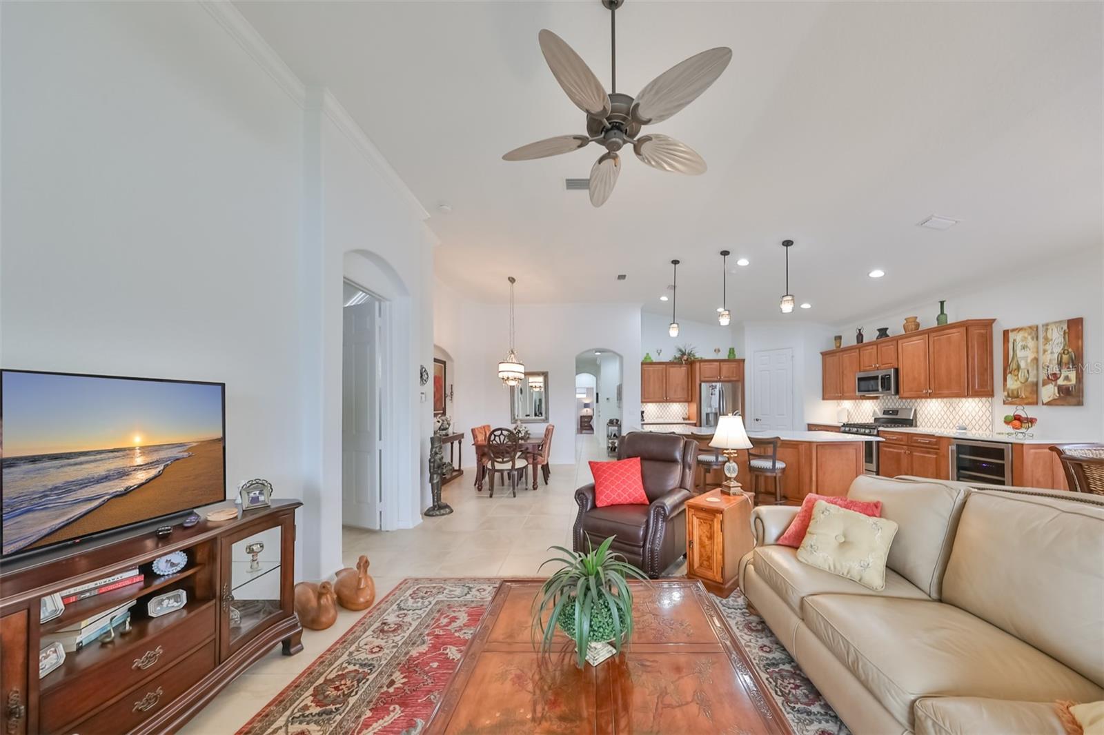 Living area has 12' ceilings, custom ceiling fan and lots of bright natural sunshine, that is open to the dining and kitchen areas.