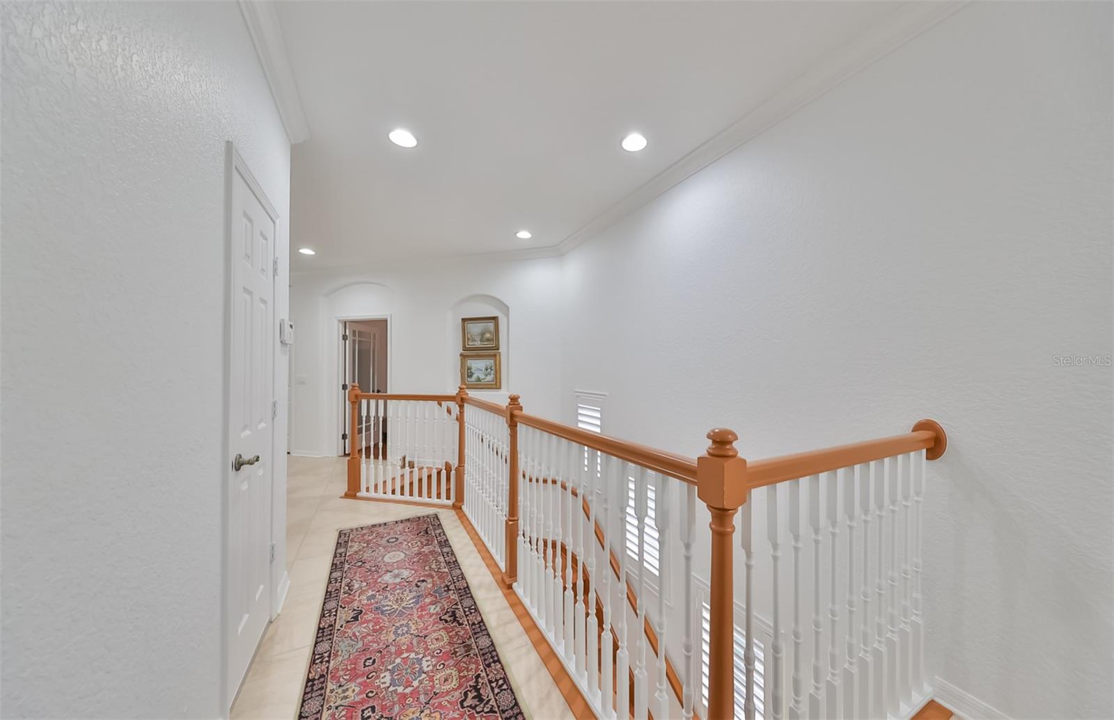 From the landing, a hallway provides additional closet space and access to the private elevator.