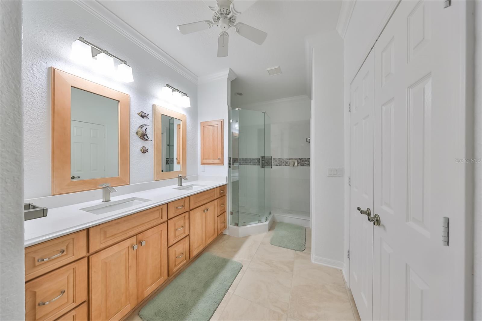 Owner suite - Ensuite Bathroom updated with wood cabinets/mirror frames/medicine cabinets, large walk in shower with high end faucets, dual sink, and separate water closet.