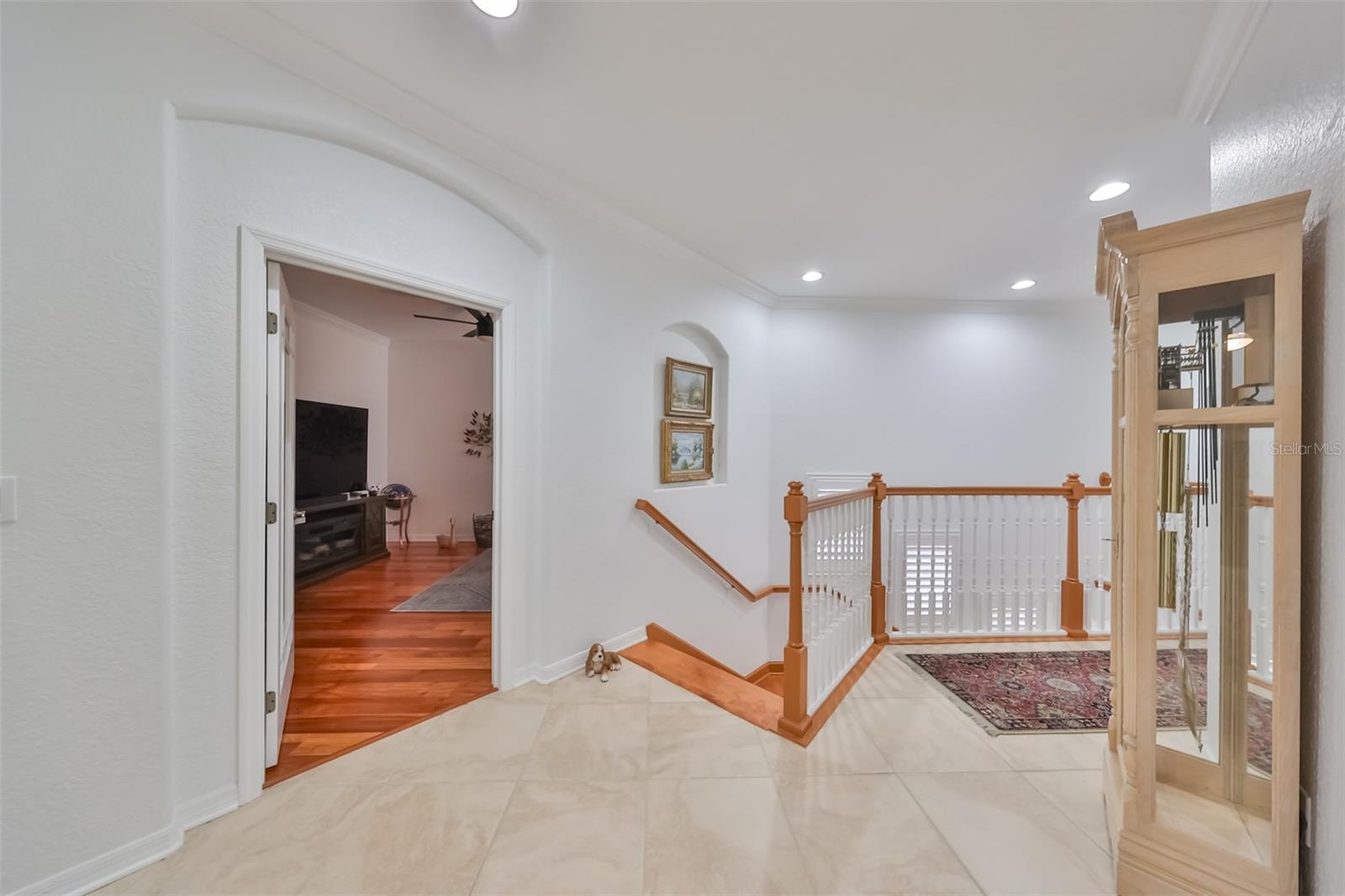 The landing at the top of the stairs is spacious, bright and open.  It is the intersection for entrances into the main living area, den/office, the elevator or the secondary bedrooms and bath.
