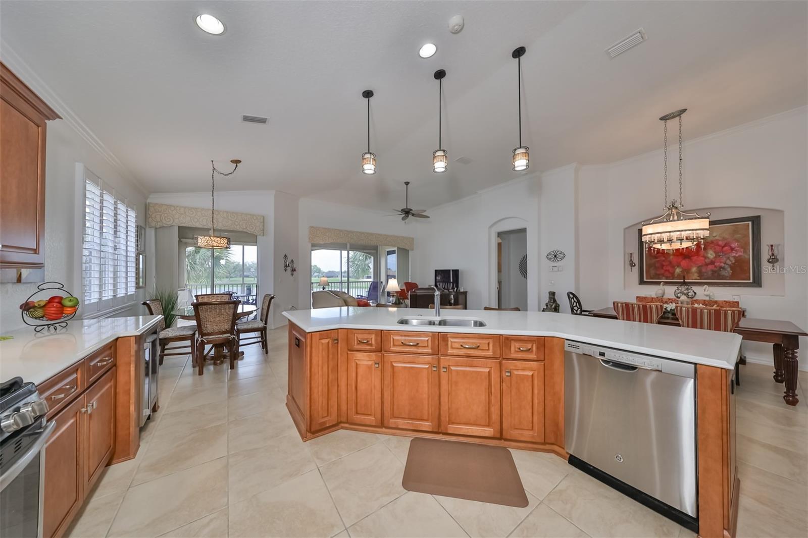 This well appointed kitchen accommodates multiple cooks. Recessed lighting, custom pendants, mass surface areas and high end appliances make task in this bright and open space enjoyable.