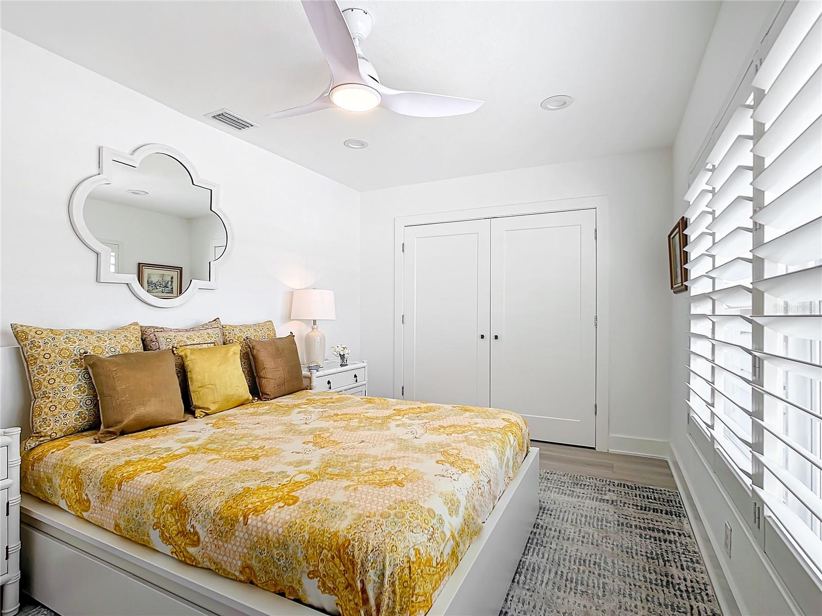 2nd bedroom, conveniently located at the front of the home, offers plantation shutters and a built-in closet with organizers.