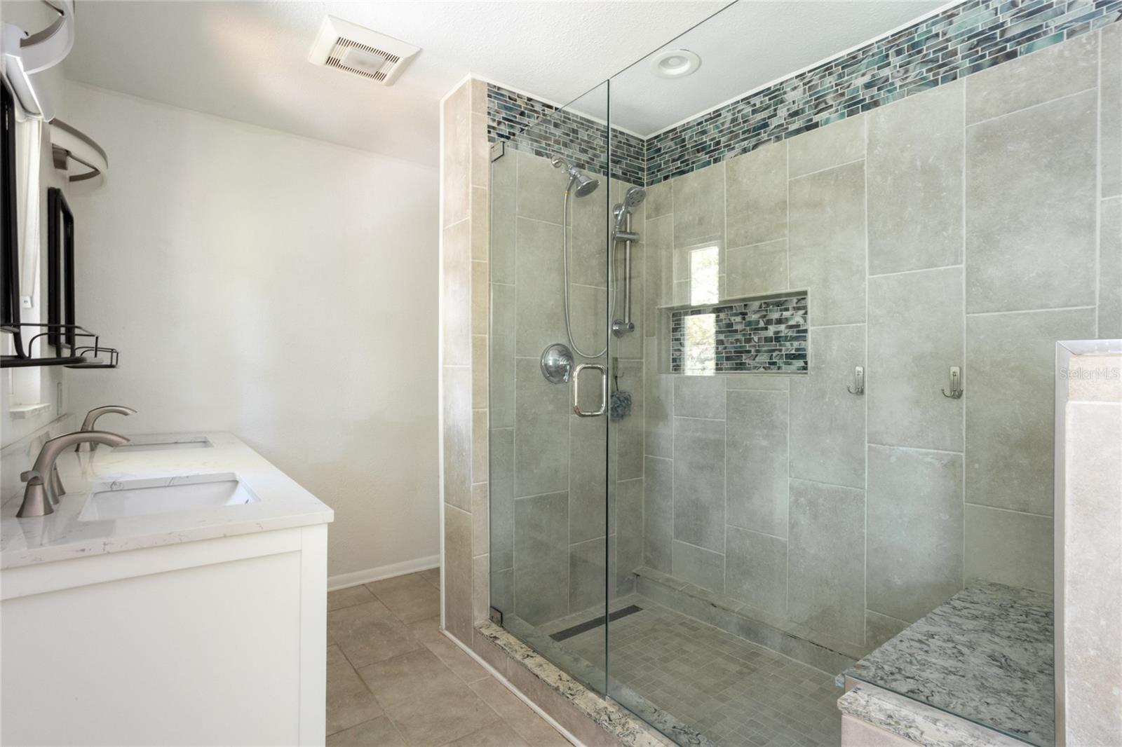 Large glass shower with sitting bench