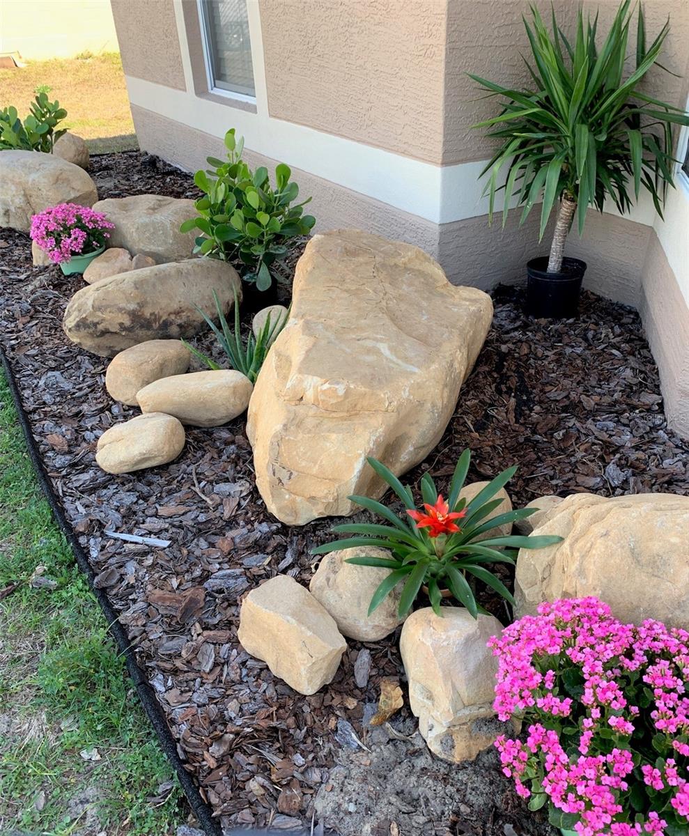 Lovely Bolders & Flowers Landscaping in front.